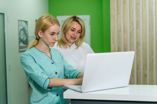 Two female women medical doctors looking at laptop in an office. Health care concept.