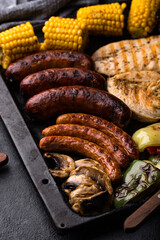 Grilled sausages, meat, and vegetables.