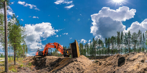 Panorama view on orange excavator that stands on top of digged from trench sand. Fully streched arm...