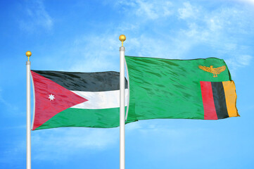Jordan and Zambia two flags on flagpoles and blue cloudy sky