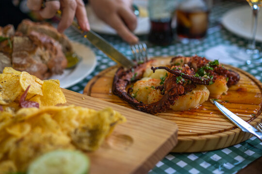 Comer plato de pulpo rockero en restaurante