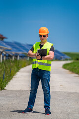 Fototapeta na wymiar Photovoltaic energy construction site. Engineer at work. Full size portrait.