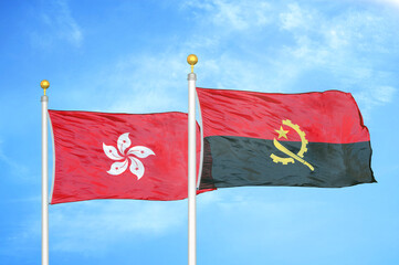 Hong Kong and Angola  two flags on flagpoles and blue cloudy sky