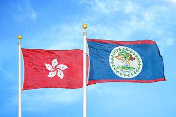 Hong Kong and Belize  two flags on flagpoles and blue cloudy sky
