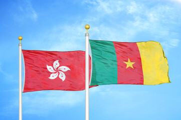 Hong Kong and Cameroon  two flags on flagpoles and blue cloudy sky