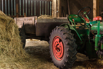 loading hay in a barn on a tractor