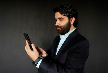 bearded businessman mid adult looking working on his smart phone