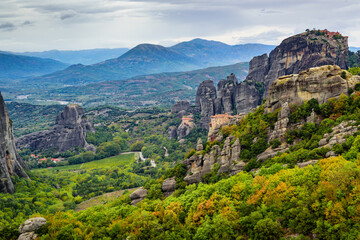 Fototapeta na wymiar View of the stunning rock formations of Meteora and Holy Monastery of Rousanou and Holy Monastery of Saint Nicholas Anapafsas at Meteora