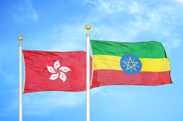 Hong Kong and Ethiopia two flags on flagpoles and blue cloudy sky