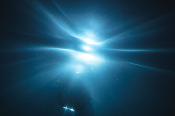 Underwater light creates a beautiful veils, consisting of sunlight. Underwater ocean waves and buoy float .