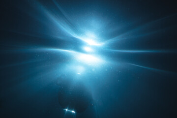 Obraz premium Underwater light creates a beautiful veils, consisting of sunlight. Underwater ocean waves and buoy float .