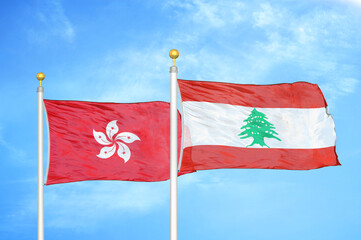 Hong Kong and Lebanon two flags on flagpoles and blue cloudy sky