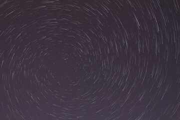 A view of the stars of the Milky Way with a mountain top in the foreground. Night sky nature summer...