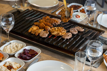 Different types of meat grilled on Barbecue on the table, Served with special Turkish appetizers and Turkish raki