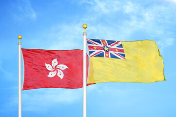 Hong Kong and Niue two flags on flagpoles and blue cloudy sky