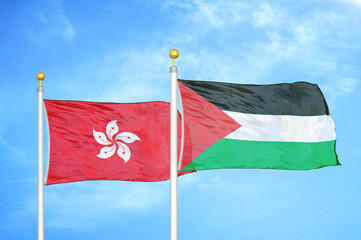 Hong Kong and Palestine two flags on flagpoles and blue cloudy sky