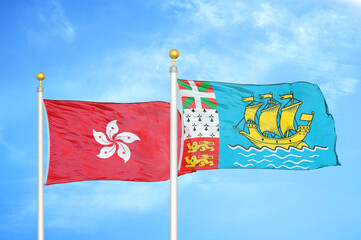 Hong Kong and Saint Pierre and Miquelon two flags on flagpoles and blue sky
