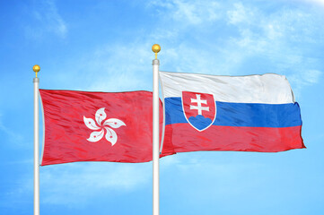 Hong Kong and Slovakia two flags on flagpoles and blue cloudy sky