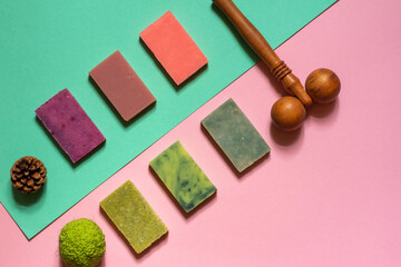 Green and purple soap made from natural herbs, berries and flowers. Layout on a colored background