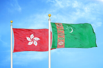 Hong Kong and Turkmenistan two flags on flagpoles and blue cloudy sky