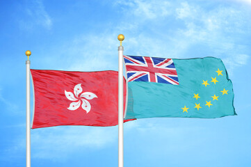 Hong Kong and Tuvalu two flags on flagpoles and blue cloudy sky
