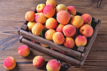 natural apricots in a wooden box on a natural wooden background, backlight soft focus