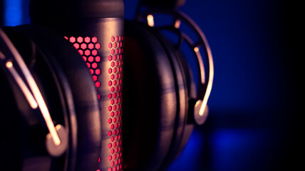 Gaming headphones with mirkophone and neon illumination diodes. Gaming devices, neon lights. Game zone.