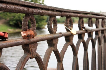 old rusty padlock on a metal fence