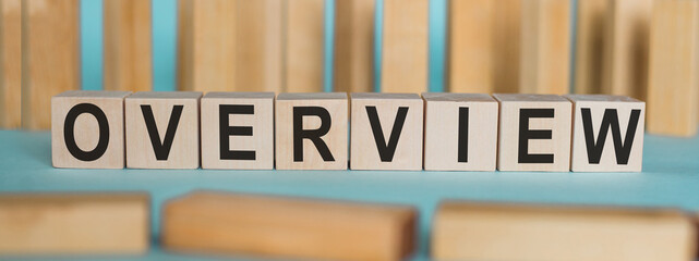 OVERVIEW word written on wood block. OVERVIEW text on blue table for your desing, concept.