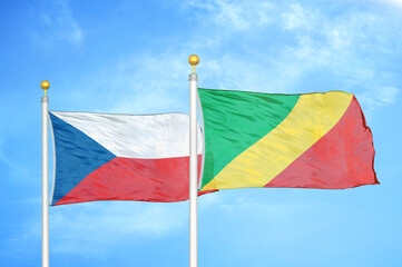 Czech and Congo two flags on flagpoles and blue cloudy sky