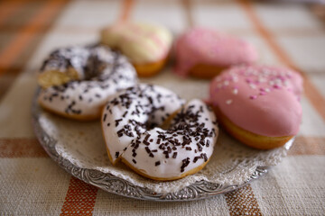 Portrait of delicious glazed donuts with sprinkles on top