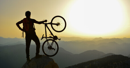 Silhouette of a man riding a bicycle