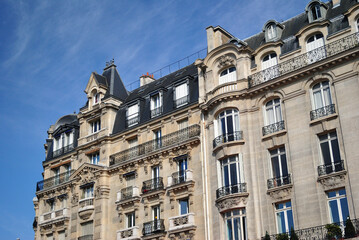 Fototapeta na wymiar 19th Century Parisian Stone Apartment Block seen from Below against Blue Sky