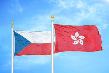 Czech and Hong Kong two flags on flagpoles and blue cloudy sky
