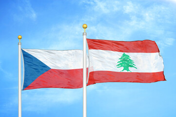 Czech and Lebanon two flags on flagpoles and blue cloudy sky