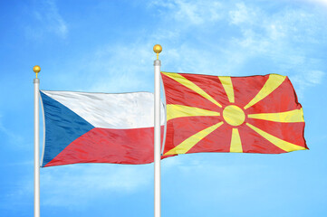 Fototapeta premium Czech and North Macedonia two flags on flagpoles and blue cloudy sky