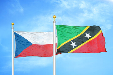 Czech and Saint Kitts and Nevis two flags on flagpoles and blue cloudy sky