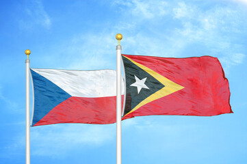 Czech and Timor-Leste East Timor two flags on flagpoles and blue cloudy sky