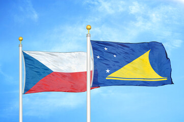 Czech and Tokelau two flags on flagpoles and blue cloudy sky