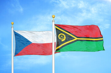 Czech and Vanuatu two flags on flagpoles and blue cloudy sky
