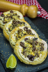 Delicious Lebanese  food, Mediterranean ricotta sfiha, olives au gratin with cheese, in the background a traditional Lebanese keffyeh.