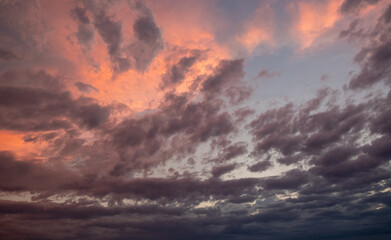 Pink sunset after rain. Black, thunderclouds and blue sky. Sunset at the sea. Summer. Georgia.