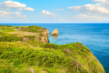 Tourists walk along the trail path on the Normandy France Coast of Pointe du Hoc, WW2 D Day battle...