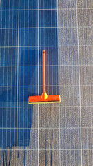 cleaning dirty solar panel at sunset