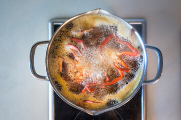 cooking velvet crabs in a pot of boiling water