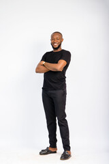 young black handsome man standing and folding his arms in front of a white background