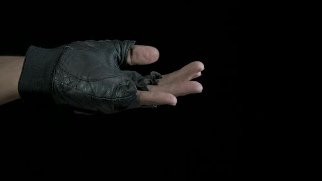 Asked food with a hand. The beggar's hand begs for alms.