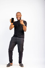young black handsome man standing holding out his smartphone, happy and giving thumbs up