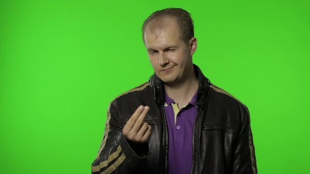 Rocker man asking for salary increase, smiling, showing money gesture, needs cash, credit, loan