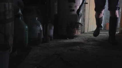 A man enters the room and takes the axe